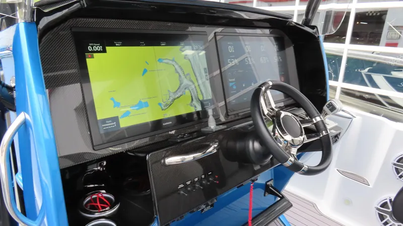 Slide: The Image of 2023 Nor-Tech 390 Sport Center Console dashboard with navigation display and steering wheel. - 8