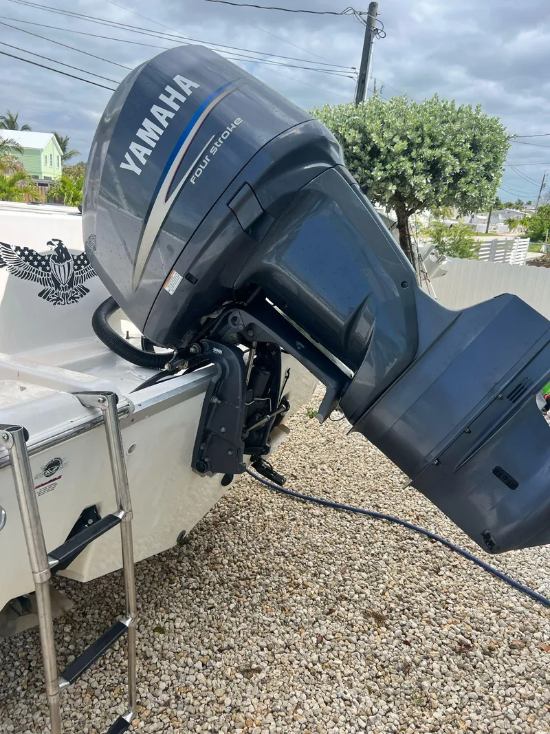 Slide: The Image of 2006 Sea Fox 257 Walk Around with Yamaha outboard motor on gravel surface. - 10