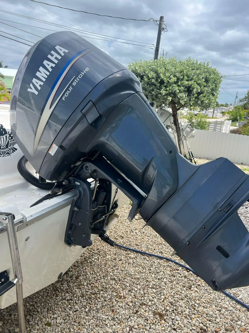 Slide: The Image of 2006 Sea Fox 257 Walk Around with Yamaha outboard motor, parked on gravel. - 11
