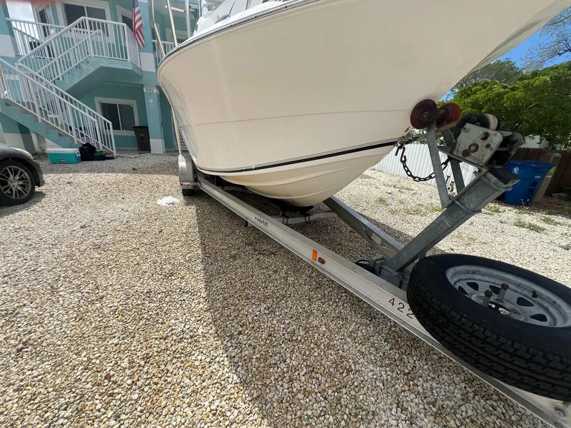 Slide: The Image of 2006 Sea Fox 257 Walk Around boat on trailer in gravel driveway. - 6