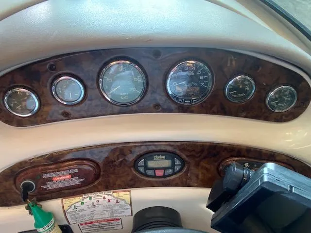 Slide: The Image of Dashboard of a 2004 Sea Ray 240 Sundeck boat with gauges and controls. - 12