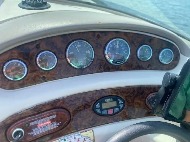 Slide: The Image of Dashboard of a 2004 Sea Ray 240 Sundeck boat with gauges and controls. - 13