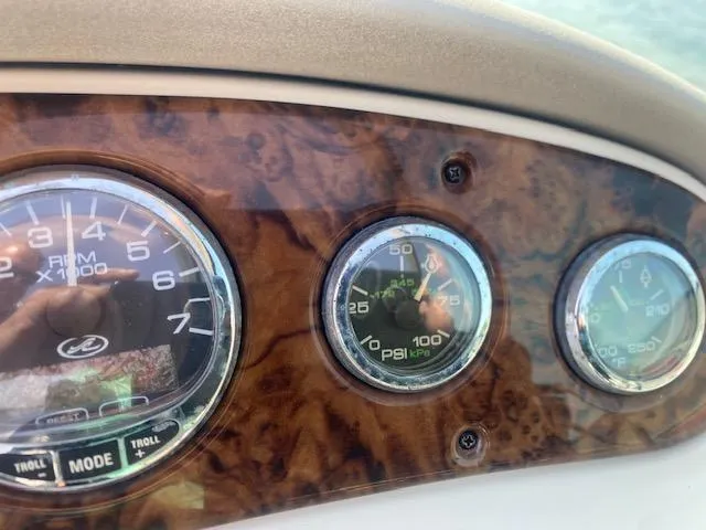 Slide: The Image of Dashboard of 2004 Sea Ray 240 Sundeck with RPM and PSI gauges. - 15