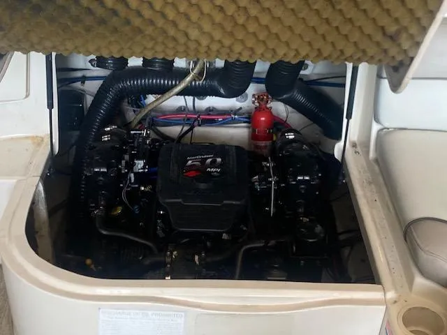 Slide: The Image of Engine compartment of a 2004 Sea Ray 240 Sundeck boat, featuring a MerCruiser engine. - 19