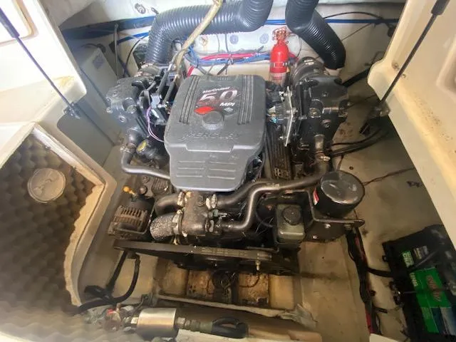 Slide: The Image of Engine compartment of a 2004 Sea Ray 240 Sundeck boat, featuring a well-maintained motor. - 20