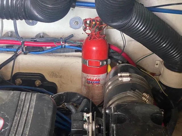 Slide: The Image of Engine compartment of a 2004 Sea Ray 240 Sundeck with fire extinguisher and wiring. - 21