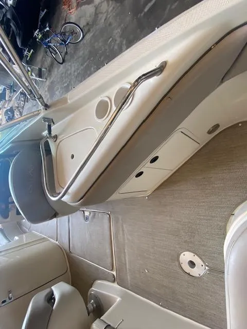 Slide: The Image of 2004 Sea Ray 240 Sundeck interior with seating and storage compartments. - 26