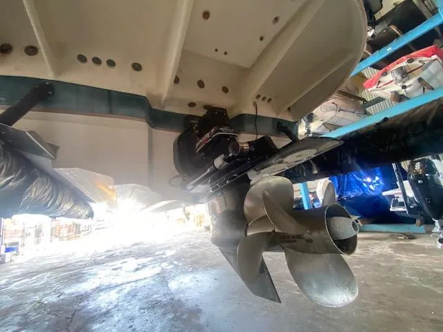 Slide: The Image of 2004 Sea Ray 240 Sundeck boat propeller and stern view in a storage facility. - 27