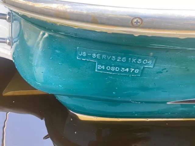 Slide: The Image of 2004 Sea Ray 240 Sundeck boat hull with visible identification numbers. - 28