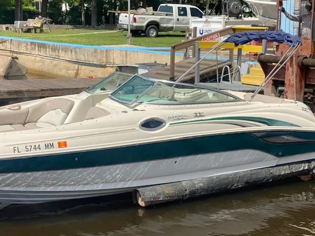 Slide: The Image of 2004 Sea Ray 240 Sundeck boat docked at a marina, featuring sleek design and comfortable seating. - 3