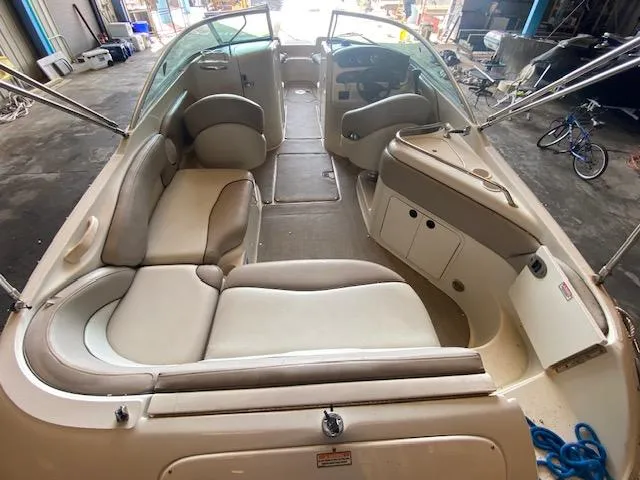 Slide: The Image of 2004 Sea Ray 240 Sundeck interior with spacious seating and sleek design. - 6