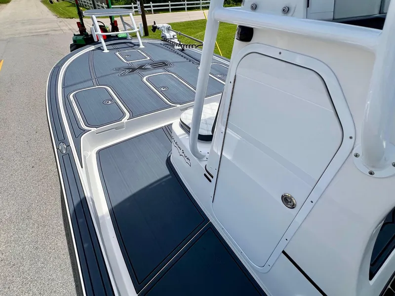Slide: The Image of 2024 Shallow Sport 25 X3 boat deck with sleek design and storage compartments. - 12
