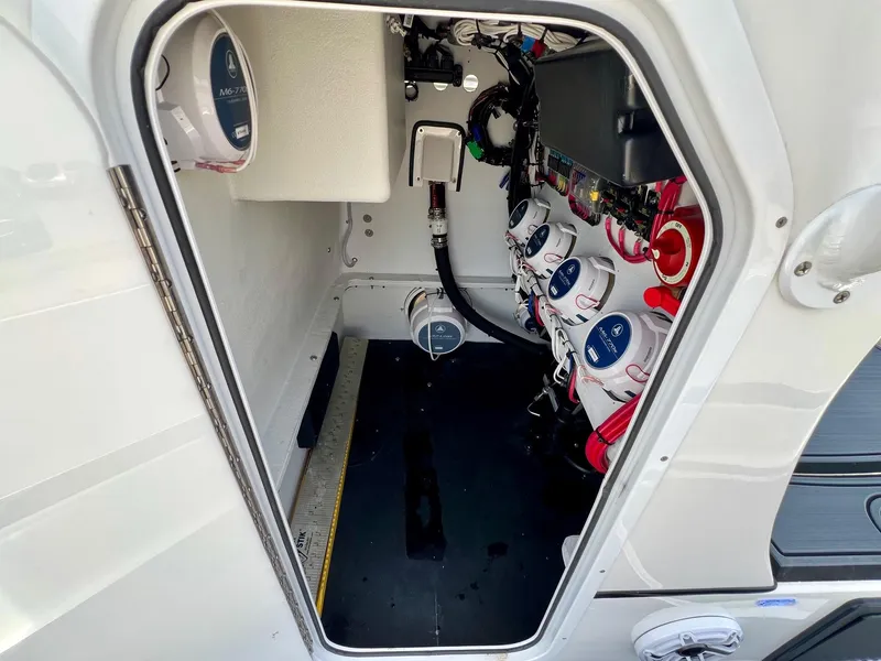 Slide: The Image of 2024 Shallow Sport 25 X3 boat interior showing electrical components and wiring. - 13