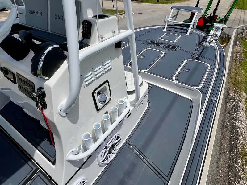 Slide: The Image of 2024 Shallow Sport 25 X3 boat deck with rod holders and Garmin equipment. - 15