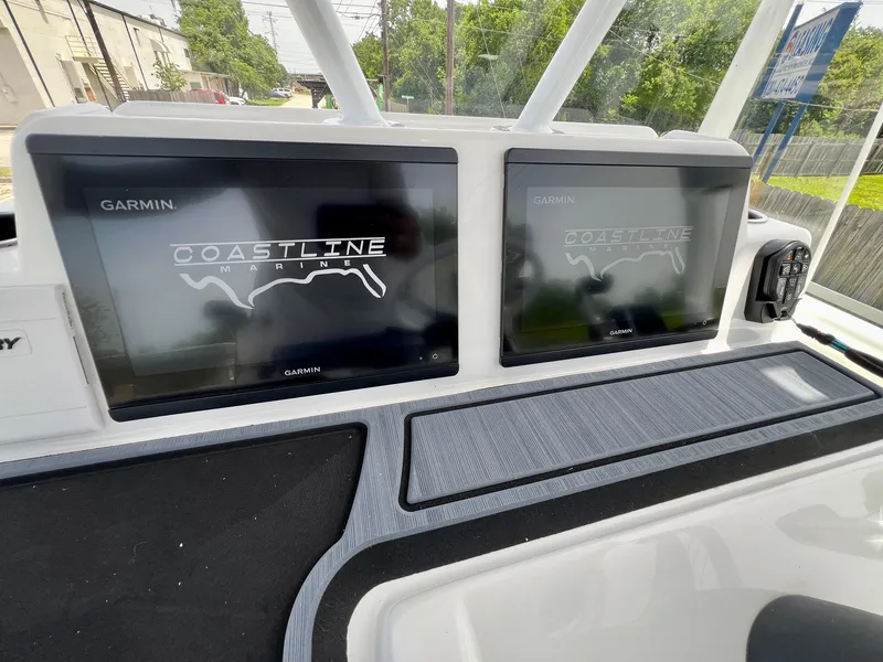 Slide: The Image of 2024 Shallow Sport 25 X3 boat dashboard with dual Garmin displays. - 17