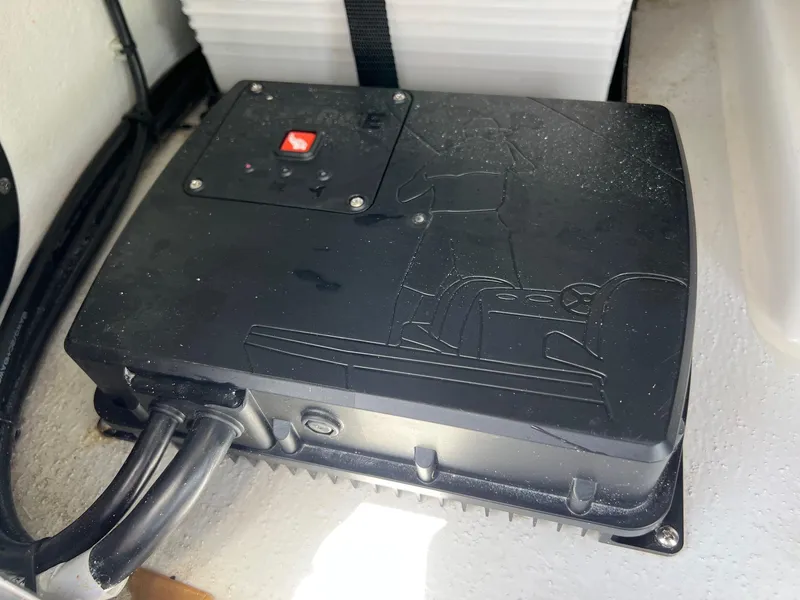 Slide: The Image of 2024 Shallow Sport 25 X3 electrical component with cables and a red button. - 23