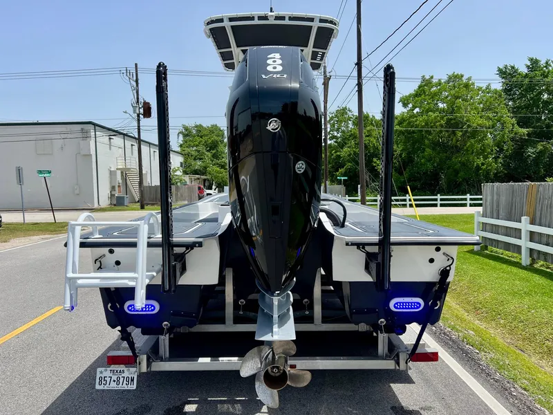 Slide: The Image of 2024 Shallow Sport 25 X3 boat with powerful outboard motor on a trailer. - 3