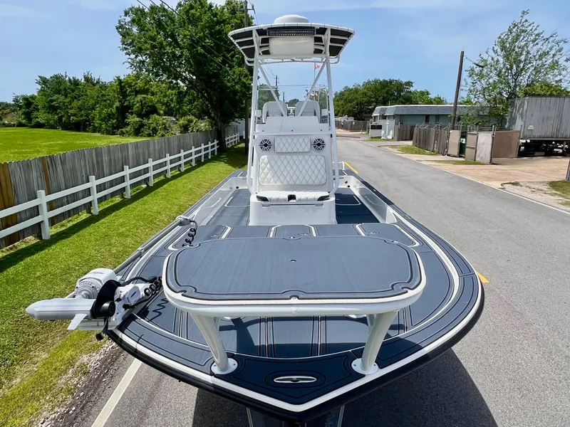 Slide: The Image of 2024 Shallow Sport 25 X3 boat on a road, showcasing sleek design and modern features. - 6