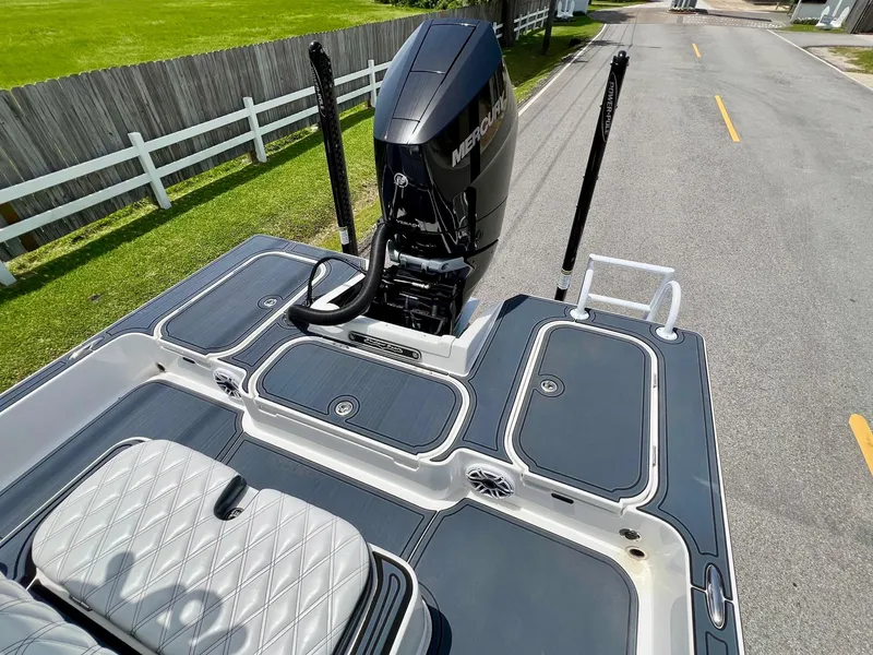 Slide: The Image of 2024 Shallow Sport 25 X3 boat with Mercury engine on a road. - 7