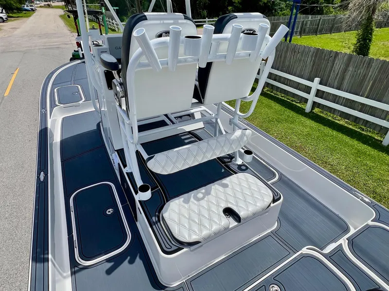 Slide: The Image of 2024 Shallow Sport 25 X3 boat deck with seating and rod holders. - 8