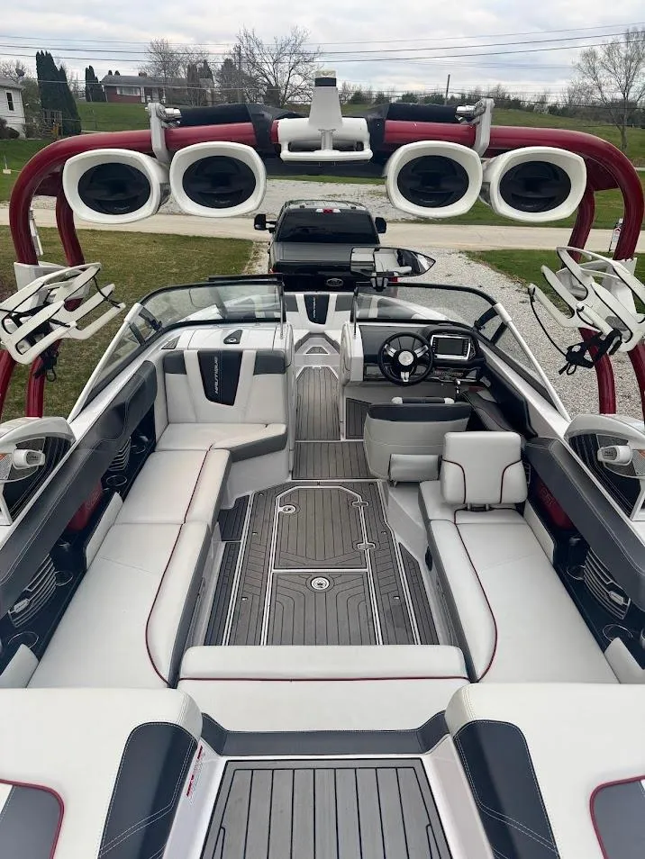 Slide: The Image of 2013 Nautique Super Air G23 boat interior with sleek seating and advanced audio system. - 10