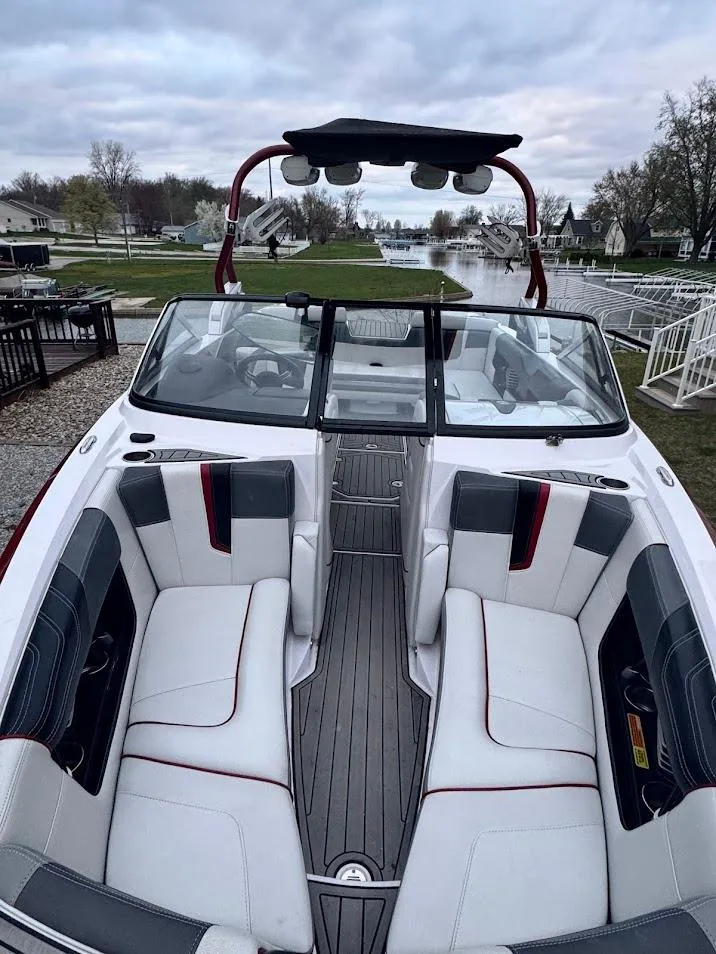 Slide: The Image of 2013 Nautique Super Air G23 boat with spacious seating and sleek design. - 16