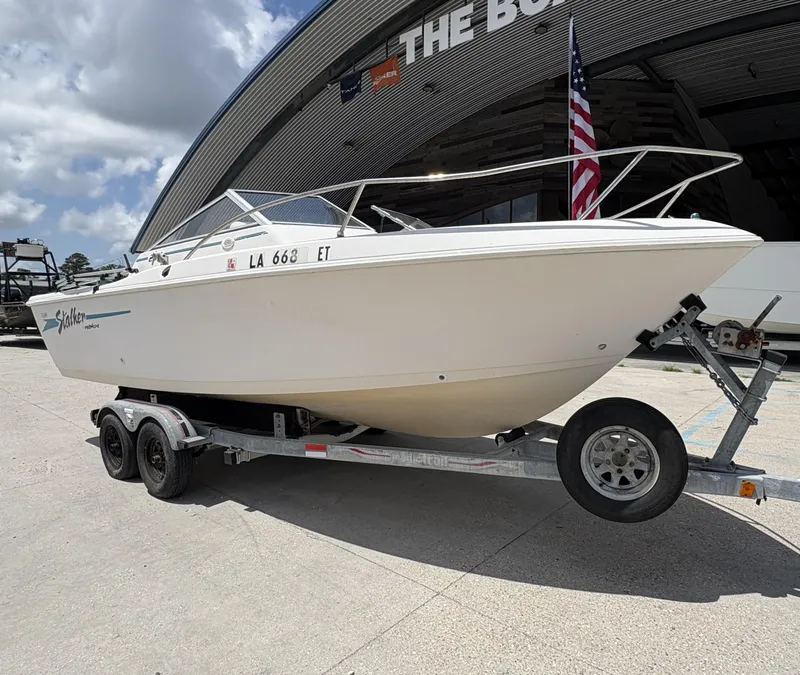 Slide: The Image of 1996 Pro-Line 202 Stalker boat on trailer under cloudy sky. - 2