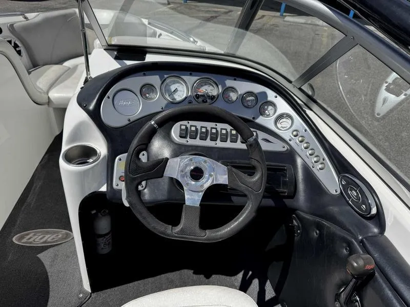 Slide: The Image of 2006 Tigé 21i boat dashboard with steering wheel and control panel. - 9