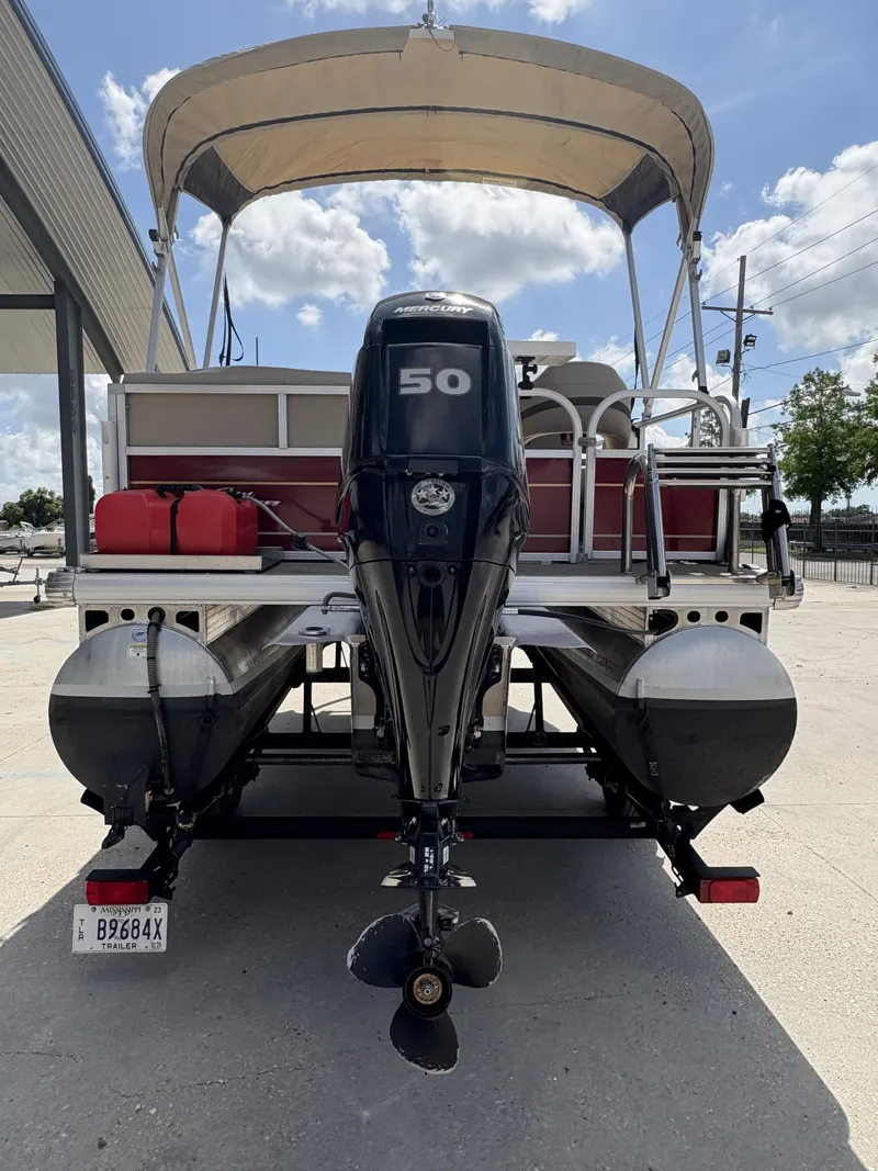 Slide: The Image of 2023 Sun Tracker Bass Buggy 16 XL pontoon boat with Mercury 50 engine, rear view. - 4