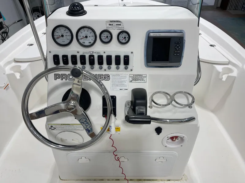 Slide: The Image of 2012 Sea Fox 180XT boat console with steering wheel, gauges, and navigation system. - 15