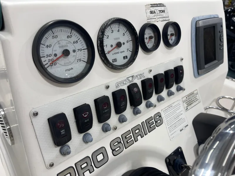 Slide: The Image of Dashboard of a 2012 Sea Fox 180XT boat with gauges and controls. - 17