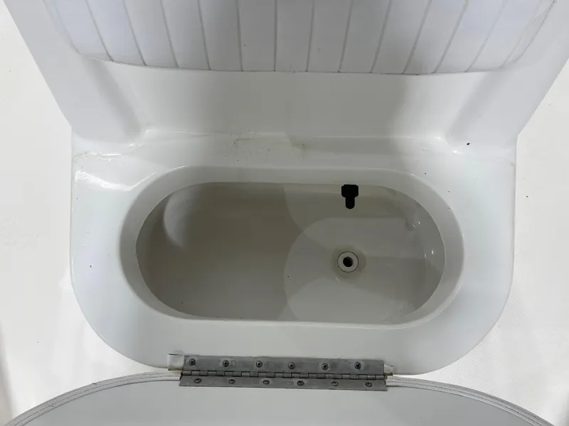 Slide: The Image of Livewell compartment in a 2012 Sea Fox 180XT boat, featuring a white interior. - 23