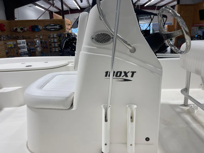 Slide: The Image of 2012 Sea Fox 180XT boat interior with steering wheel and seating in showroom. - 8
