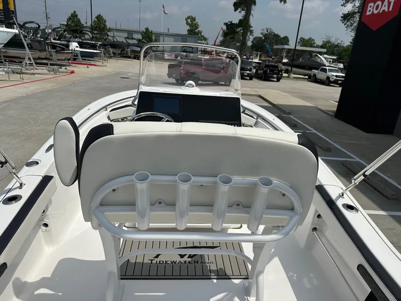 Slide: The Image of 2025 Tidewater 198CC boat interior with rod holders and console, displayed at a dealership. - 12