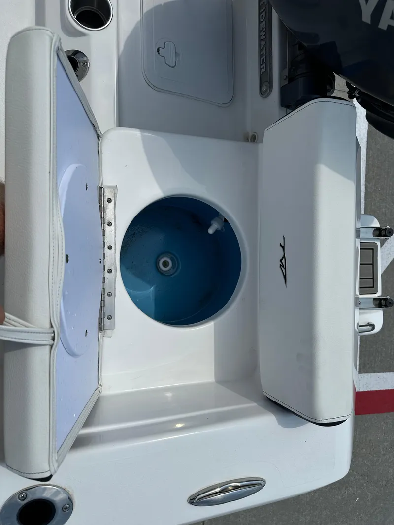 Slide: The Image of 2025 Tidewater 198CC boat interior with open storage compartment and Yamaha engine. - 20