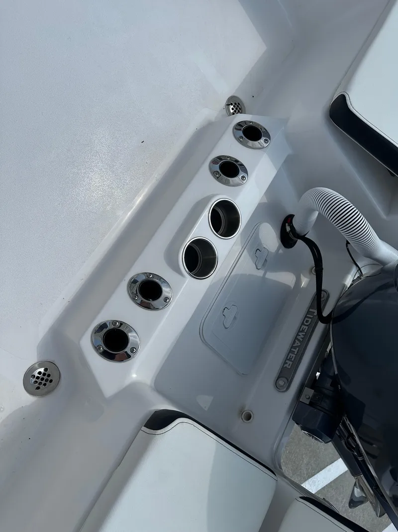 Slide: The Image of 2025 Tidewater 198CC boat interior with cup holders and storage compartment. - 21
