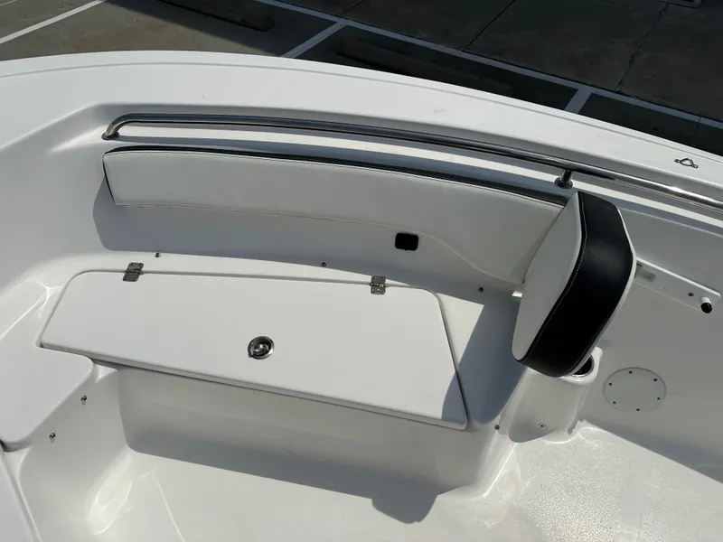 Slide: The Image of 2025 Tidewater 198CC boat interior seating with storage compartment, featuring sleek white and black design. - 24