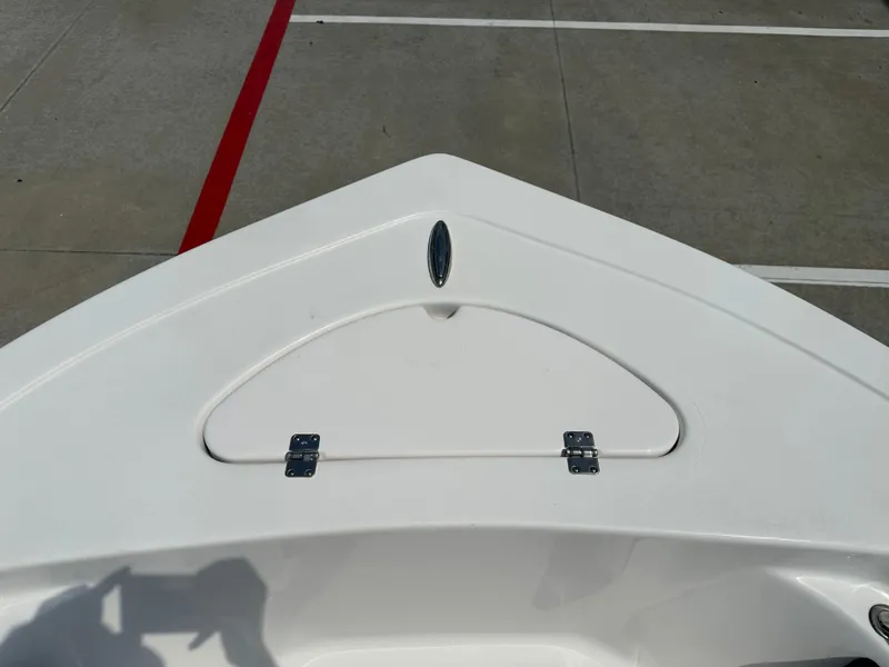 Slide: The Image of Bow of 2025 Tidewater 198CC boat with storage compartment, parked on concrete. - 30