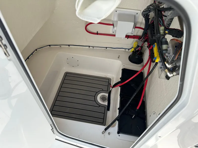 Slide: The Image of 2025 Tidewater 198CC boat interior wiring and storage compartment. - 33