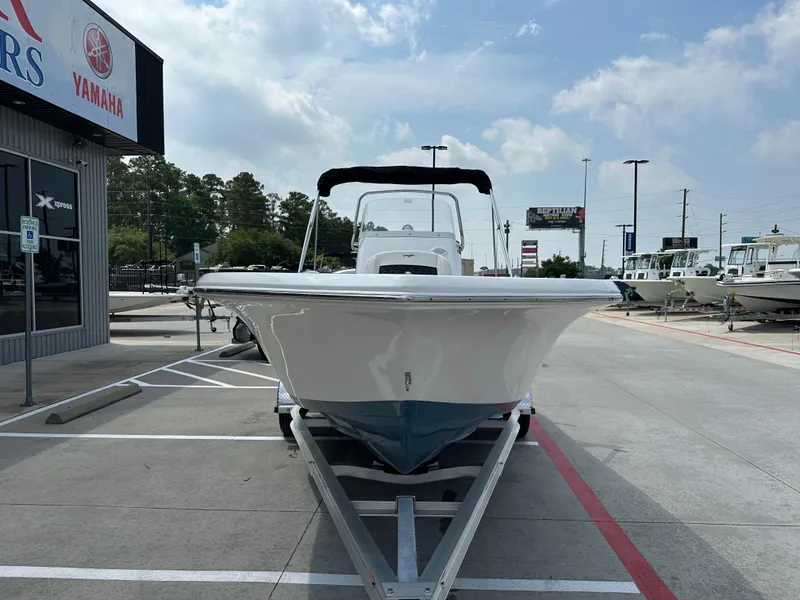Slide: The Image of 2025 Tidewater 198CC boat on trailer at dealership, clear sky background. - 5