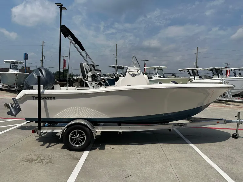 Slide: The Image of 2025 Tidewater 198CC boat on trailer, displayed outdoors under a cloudy sky. - 7