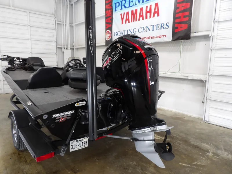 Slide: The Image of 2023 Tracker PRO190TX boat with Yamaha engine displayed indoors. - 11