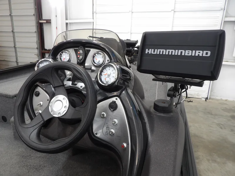 Slide: The Image of 2023 Tracker PRO190TX boat dashboard with steering wheel and Humminbird fish finder. - 12