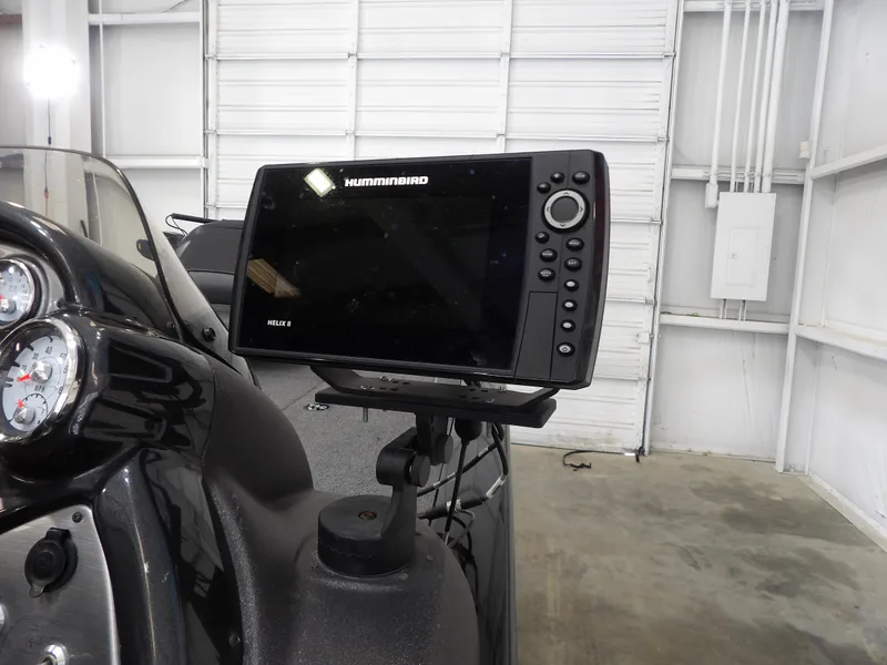 Slide: The Image of 2023 Tracker PRO190TX boat with Humminbird Helix 8 fish finder in a garage setting. - 13