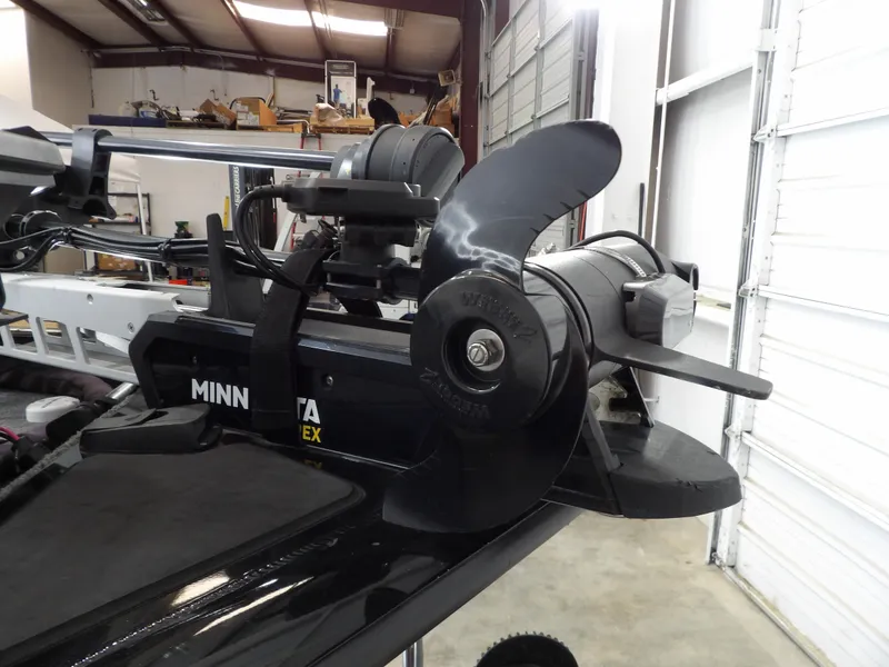 Slide: The Image of 2023 Tracker PRO190TX boat with Minn Kota trolling motor in a garage setting. - 14
