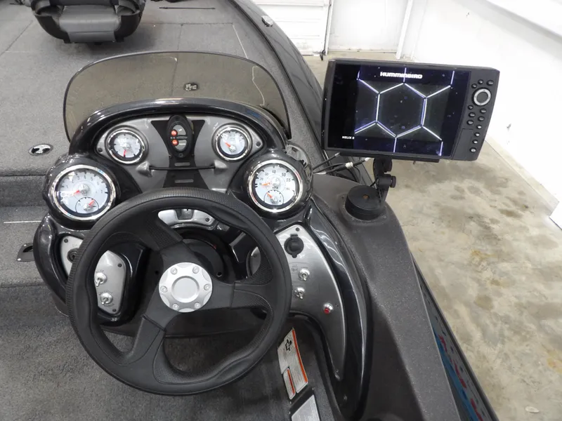 Slide: The Image of 2023 Tracker PRO190TX boat dashboard with steering wheel and electronic display. - 23