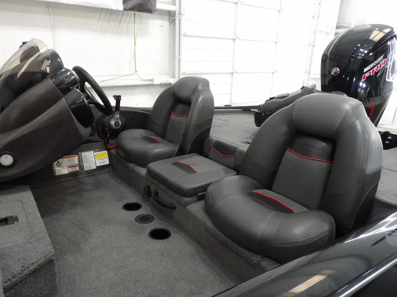 Slide: The Image of 2023 Tracker PRO190TX boat interior with black leather seats and steering console. - 9