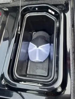 Slide: The Image of 2024 iKon LX 21 storage compartment with a hat inside. - 16