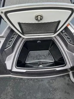 Slide: The Image of 2024 iKon LX 21 boat storage compartment with open hatch, showcasing interior space. - 18