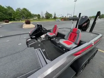 Slide: The Image of 2024 iKon LX 21 boat with red and gray seats in a parking lot. - 4